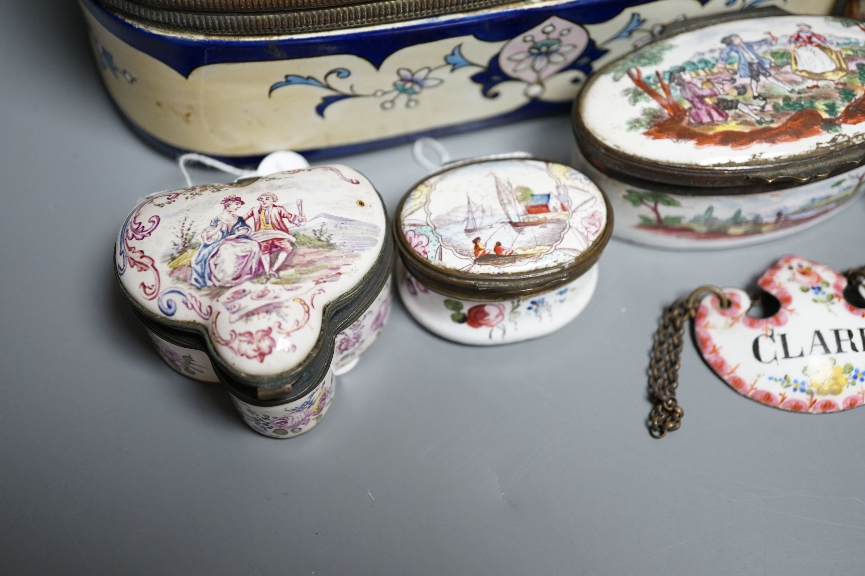 A group of five English and Continental enamel and porcelain patch and other boxes and two spirit labels, largest 20 x 8cm